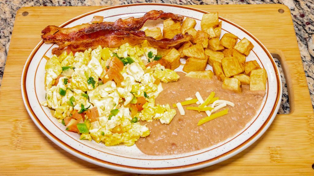 Eggs A La Mexicana Plate · Scramble eggs with pico de gallo and two strips of bacon beans and potatoes