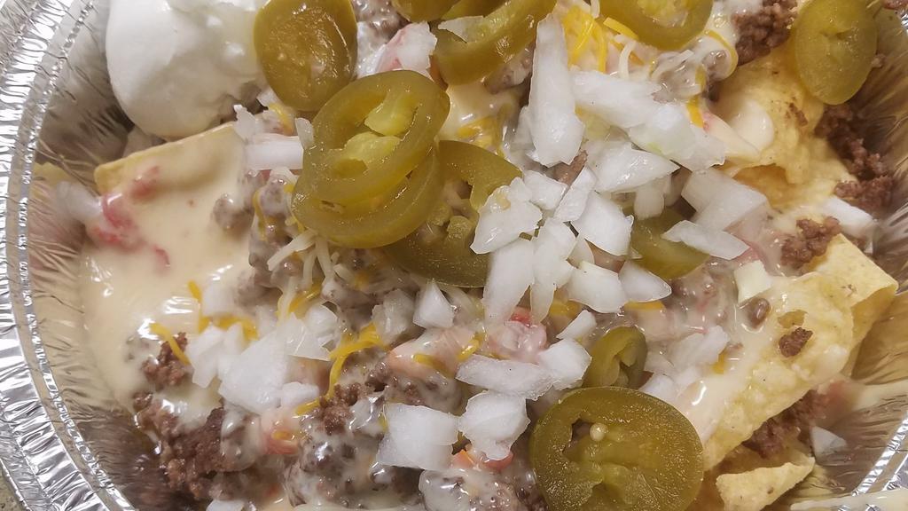 Nachos Ultimate  · Ground Beef, Queso, Shredded Cheese, Tomatoes, Onions, Jalapenos, Homemade Salsa, Sour Cream
