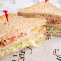 Club Supreme · Smoked ham and turkey layered on toasted honey wheat bread with bacon, American, and swiss c...