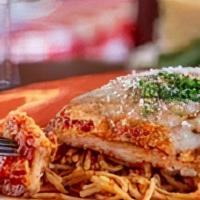 Chicken Parmesan · Tender chicken breast lightly seasoned with Italian bread crumbs, topped with Russo's homema...