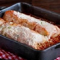 Chicken Manicotti · Fresh pasta stuffed with chicken, fresh spinach, ricotta cheese, and topped with Russo's hom...
