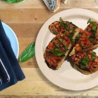 Bruschetta · tomato crudo, fresh basil pesto, garlic, grilled sourdough bread