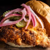Nashville Hot Chicken Sandwich · Crispy chicken tossed in our house-made spice blend and topped with pickled red onions and p...