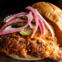 Nashville Hot Chicken Sandwich · Crispy chicken tossed in our house-made spice blend and topped with pickled red onions and p...