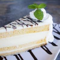 Tres Leches Cheesecake · Triple layer cake with vanilla sponge cake, cheesecake, tres leches and cream cheese icing