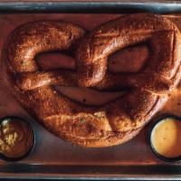 Pretzel · Locally baked pretzel from 'Cake & Bacon'.  Served with whole grain mustard and Cheddar beer...