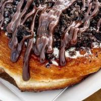 Oreo Cheesecake Kronut · Cream cheese, oreo crumbs, and chocolate icing.