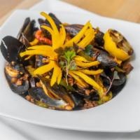 Mejillones Con Chorizo · Steamed mussels topped with Mexican chorizo and cilantro. May be served raw or undercooked; ...