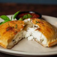 Calzone · Sausage, mozzarella and ricotta cheese stuffed and folded into fresh pizza dough  and baked ...