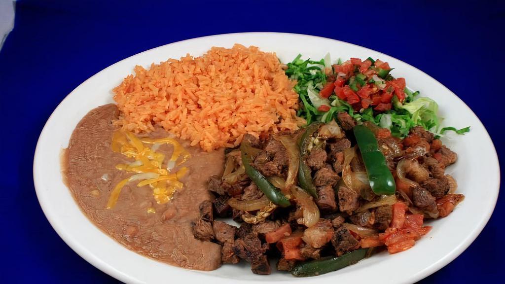 Bistec Ranchero · Chopped top sirloin prepared with onions, tomatoes & jalapeños in ranchero sauce. served with rice, refried beans, guacamole, pico de gallo & fresh tortillas.