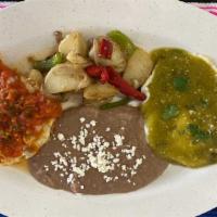 Huevos Divorciados · Two sunny eggs, topped with green & red salsa.
served with refried beans & Potatoes
