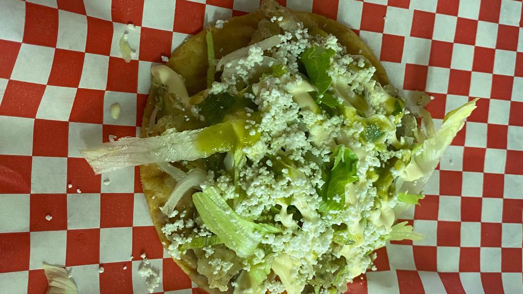 Tostadas · Refried beans, meat of your choice, Chicken or beef  fajita, Tinga,  pata.
Garnished with lettuce, green sauce, queso fresco & sour cream.