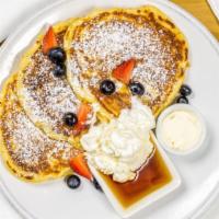 Classic Buttermilk Pancakes · Three jumbo buttermilk pancakes served with warm maple syrup, powdered sugar, salted butter ...