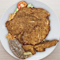 Milanesa De Res O Pollo · Fried steak served with French fries, rice, refried beans, and side salad / servido con papa...