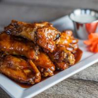 Buffalo Wings (Bone-In) · Big, meaty chicken wings, never frozen, seasoned with our special mix of spices and tossed w...