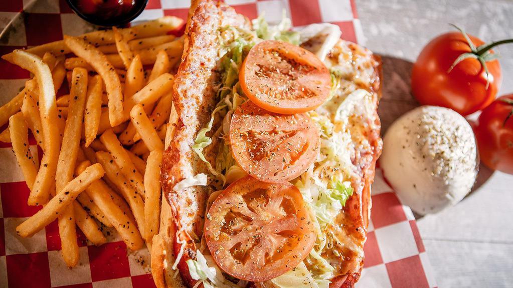 Italian · Capicola, salami, ham, lettuce, tomatoes, melted hand-grated mozzarella, Italian dressing and oregano, served with pickled giardiniera on the side.