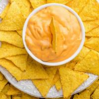 Chips & Queso · Tasty tortilla chips and creamy home-made queso dip.