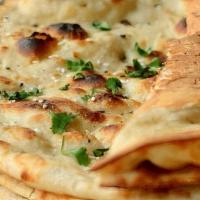 Garlic Naan. · leavened dough . tandoor cooked .  topped with butter and garlic
