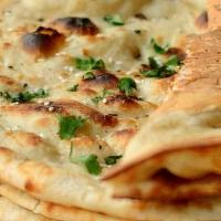 Butter Naan. · leavened dough . tandoor cooked .  topped with butter