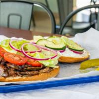 Doner Kebab · A mix of beef and lamb, perfectly seasoned and shaved onto a fresh-baked Turkish bun topped ...