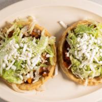 Sopes Mexicanos (2) · Two homemade tortillas with refried beans, your choice of meat, lettuce, onions and queso fr...
