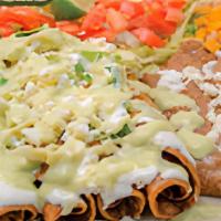 Chicken Flautas · 4 CORN FRIED TACOS served with lettuce, queso fresco, sour cream. Served with refried beans ...