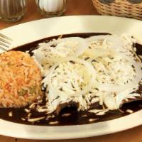 Enchiladas Mole Poblano · Fried tortillas sautéed with Mole poblano. Served with Mexican cheese, sour cream, onions an...