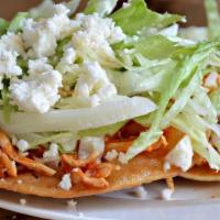  Tostada · Served  with lettuce, queso fresco and sour cream.