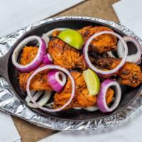 Tandoori Chicken · Chunks of chicken on the bone marinated in yogurt and delicious Indian spices – grilled to s...