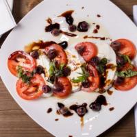 Caprese Salad · Fresh Mozzarella, sliced tomatoes, basil, capers, black olives, roasted red peppers, topped ...