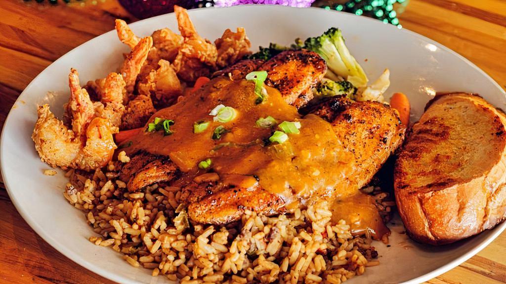 Catfish Opelousas · Two blackened fillets, topped with etouffee and fried shrimp, served with dirty rice and mixed vegetables.