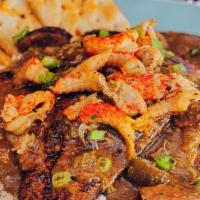 Catfish Tout · Two blackened fillets on a bed of white rice, smothered with a mixture of gumbo, etouffee an...