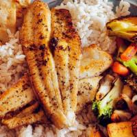 Lemon Pepper Catfish · Two seasoned fillets, broiled and served on a bed of white rice with mixed vegetables.