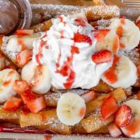 Strawberry Banana Nutella Funnel Cake Fries · Fresh bananas, fresh strawberries, real strawberry puree, Nutella, powdered sugar, and whipp...