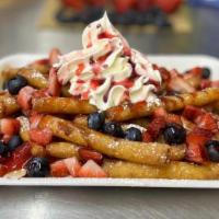 Very Berry Funnel Cake Fries · Our Funnel Cake Fries, covered in powdered sugar, topped with fresh cut strawberries, bluebe...