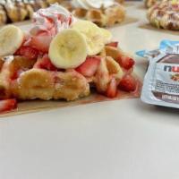 Strawberry Banana Nutella Waffle · Our delicious Belgian Pearl Sugar waffle, dusted with powdered sugar, topped with fresh cut ...