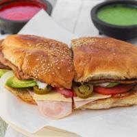 Torta · Served with ham, swiss cheese, onion, avocado, tomato, mayonnaise, and jalapeno/ Con jamón, ...