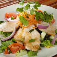 Thai Chicken Salad · Sliced of grilled chicken breast atop European baby greens and Thai vinaigrette dressing.