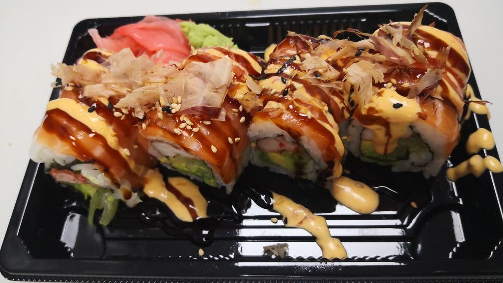 Yammy Yammy Roll · Imitation crab, avocado, cucumber, cream cheese wrapped with salmon on top, drizzled with eel sauce, spicy mayo, and bonito flakes.