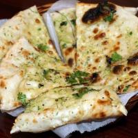 Garlic Naan · Leavened white flour bread topped with fresh garlic & coriander and baked in tandoor.