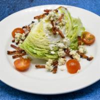 Iceberg Lettuce Wedge · Hickory-smoked bacon crumbles, tomatoes, blue cheese dressing.