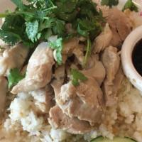 Kao Man Kai · Steamed sliced chicken or fried chicken served on a bed of jasmine rice, accompanied by slic...
