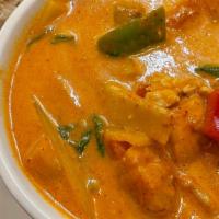 Red Curry · Spicy red curry with coconut milk, bamboo shoots, pineapple, bell peppers, tomatoes, and bas...