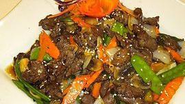 Sesame Beef · Deep-fried beef marinated with house special sauce, mushrooms, onions, carrots, snow peas, and sesame seeds.