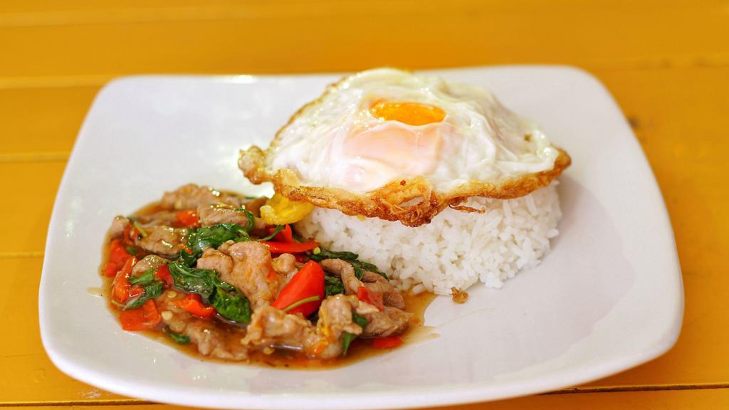 Pad  Kra Prow With Fried Egg · Minced ground pork/chicken/beef sauteed with fresh chilies, garlic, onions, bell peppers, green beans, and basil. Topped with fried egg.