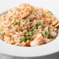Shrimp Fried Rice · Small whole shrimp with rice.  There will also be bits of egg, carrots, peas, onions, and se...