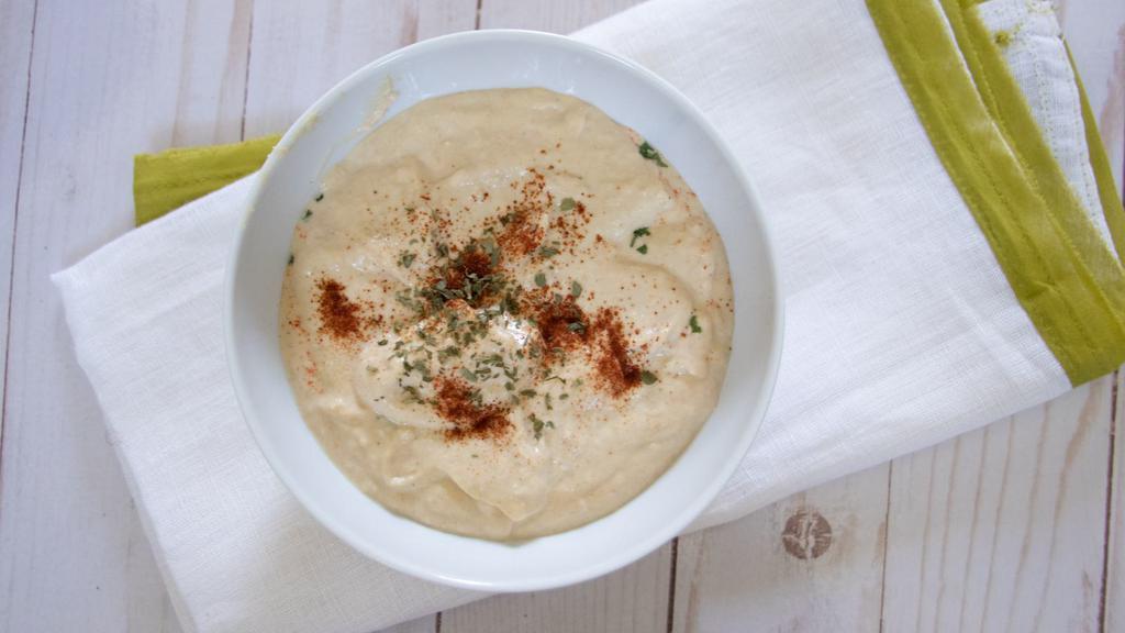 Hummus · The famous mashed chickpea mixture with fresh lemon juice, tahini sauce, and garnished with olive oil.