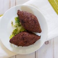 Kibbi · One piece, oval shaped ground beef, stuffed with minced meat, sauteed onions, pine nuts and ...