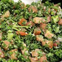 Tabbouli Salad · Freshly cut parsley, diced tomatoes, onions and crushed wheat, flavored with lemon juice and...