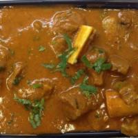 Goat Curry · Goat sautéed and cooked in curry sauce and masala.